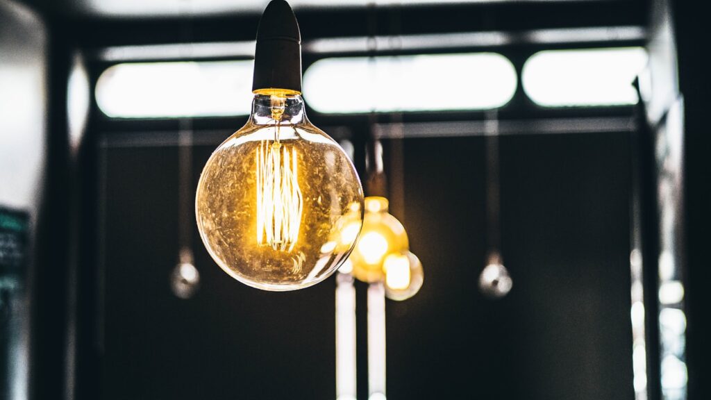 Pendant filament bulbs lit against a dark shopfront ceiling.